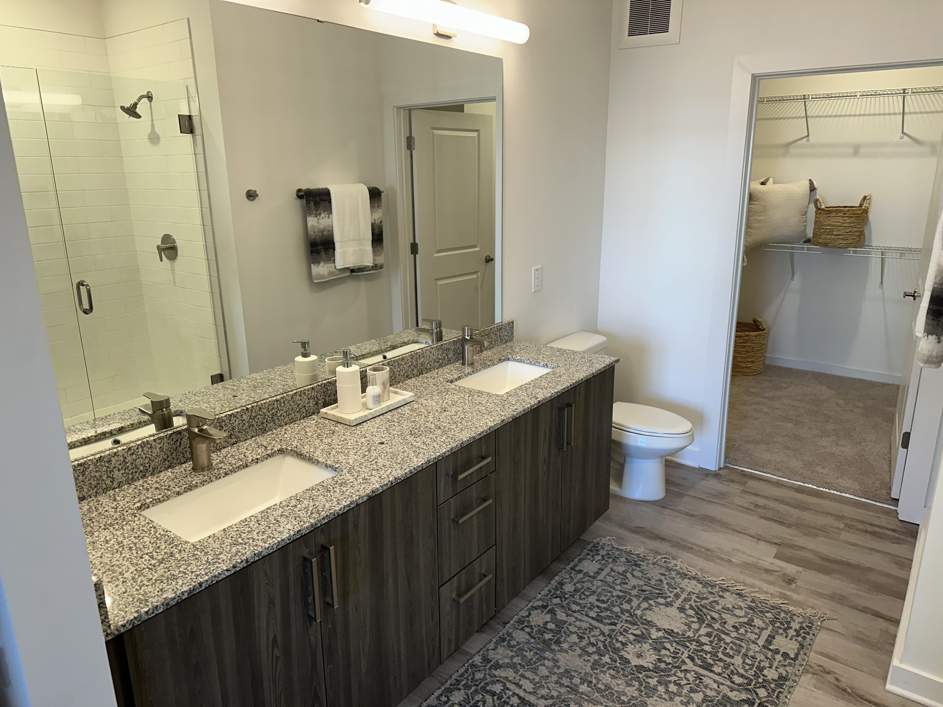 A freshly cleaned Atlanta primary bathroom with granite vanity